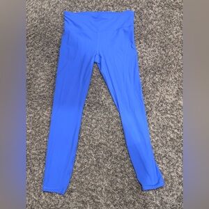 Purple high-waisted athletic leggings with ribbed texture.